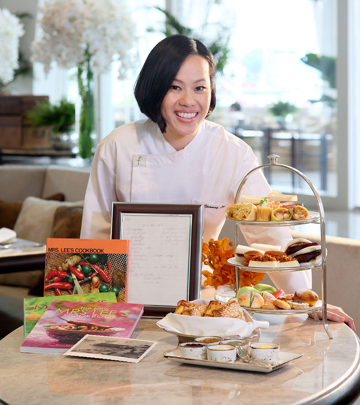 Shermay with The New Mrs Lee cookbooks, and signature dishes and accolades